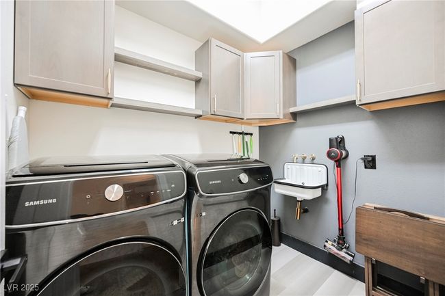Downstairs Laundry Room with independent washer and dryer and cabinet space | Image 36