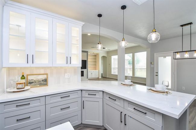 Miles of countertop space with your quartz countertops make the perfect buffet lines during your family get-togethers. Extensive cabinetry in your soft close cabinets means plenty of storage solutions to make your kitchen neat and tidy! | Image 11