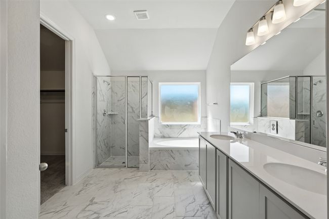 Bathroom with a garden tub, a marble finish shower, double vanity, marble finish flooring, and recessed lighting | Image 21