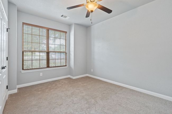 Carpeted spare room with baseboards and ceiling fan | Image 24