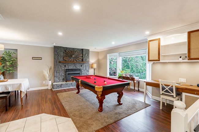 Living Room with a fireplace, wood finished floors, and crown molding | Image 11
