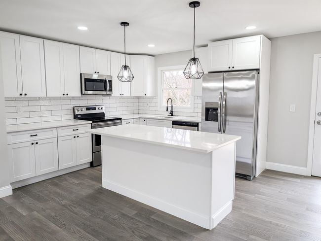 Kitchen with appliances with stainless steel finishes, dark wood-style flooring, and tasteful backsplash | Image 6