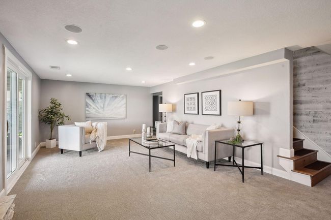 Stairway is accented with a shiplap wall, wood steps, and an open feel. | Image 22