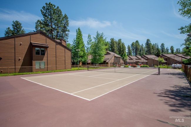 View of tennis court featuring community basketball court and a residential view | Image 24