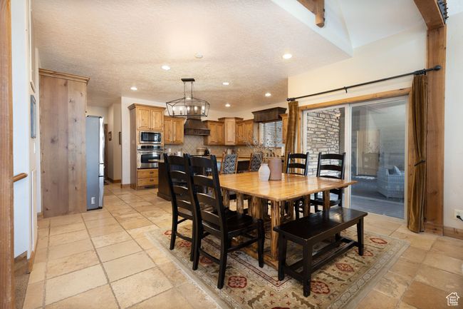 Dining room featuring baseboards, recessed lighting, stone tile flooring, and a textured ceiling | Image 27