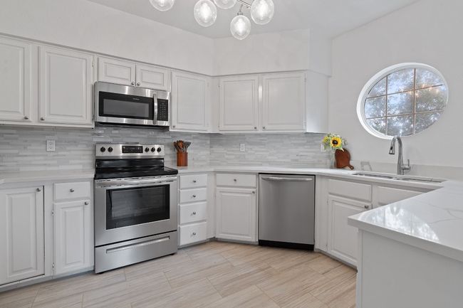 Huge kitchen with beautiful new quartz countertops and peaceful morning sun overlooking the quiet cove. | Image 10