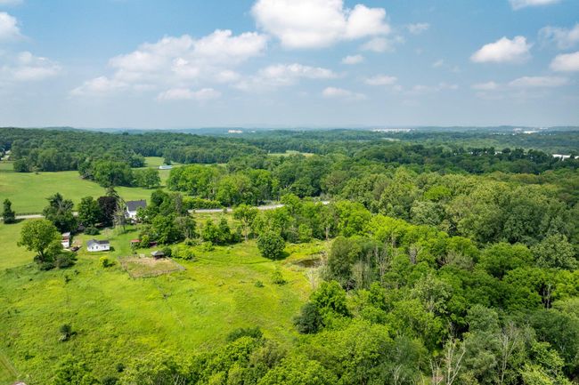 Overview of rural landscape with a heavily wooded area | Image 32