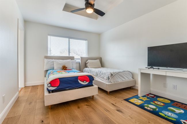 Bedroom featuring baseboards, wood finished floors, and ceiling fan | Image 26