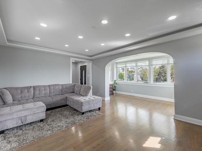 Sun-drenched living room with gleaming hardwood fl | Image 12