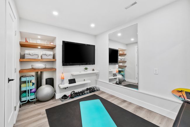 Workout area with wood finished floors, baseboards, visible vents, and recessed lighting | Image 30