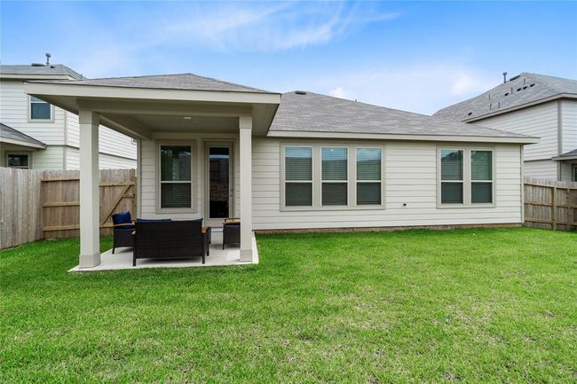 Come and see this spacious backyard with its beautiful covered patio. There is plenty of room for the kids to play and adults to relax! | Image 20
