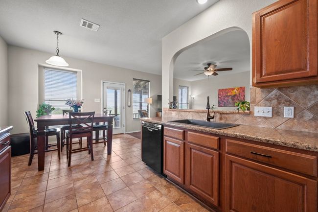 A charming eat-in kitchen & upgraded composite sink. | Image 6