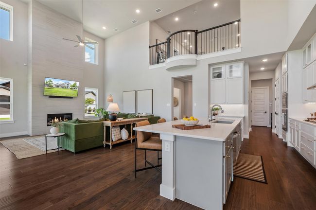 Beautiful wood flooring throughout all the main living areas of this amazing open floor plan. | Image 9