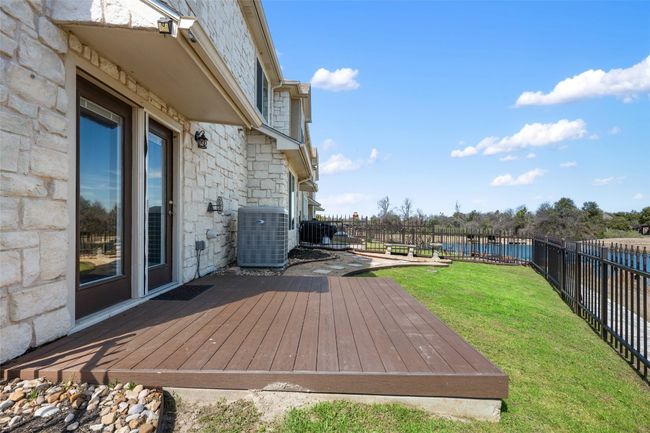 Deck with a fenced backyard, central AC, and a yard | Image 30