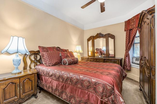 Bedroom featuring light colored carpet and ceiling fan | Image 6