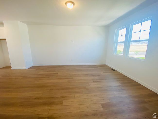 Spare room with light wood-type flooring and baseboards | Image 7