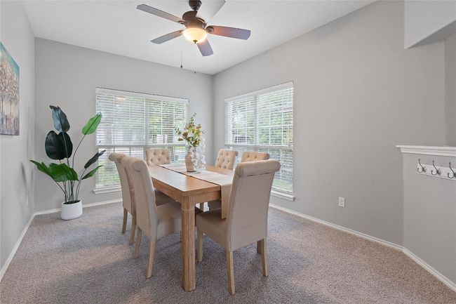 Carpeted dining space featuring baseboards and a ceiling fan | Image 13