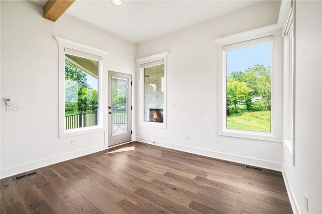 Empty room with dark wood-type flooring, baseboards, and recessed lighting | Image 40