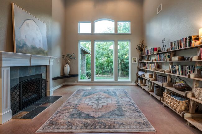 Large living area shown without virtual staging. Notice the attached tiered bookshelves! | Image 23