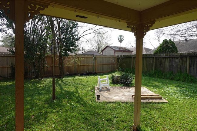 Enjoy a serene view of the spacious backyard and covered patio right from your kitchen. | Image 16