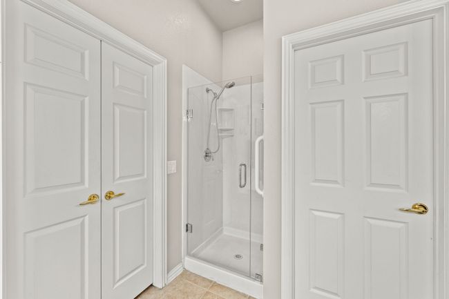Full bath featuring a shower stall and tile patterned flooring | Image 33