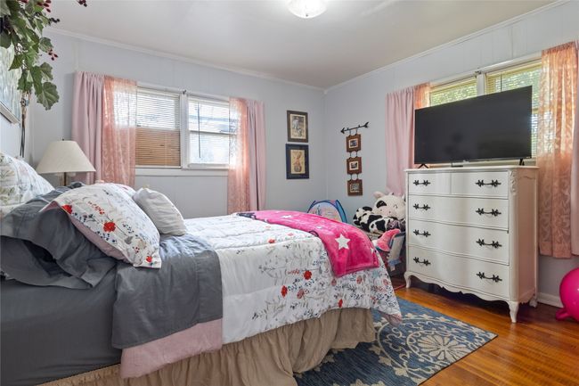 Bedroom featuring crown molding, multiple windows, and wood finished floors | Image 19
