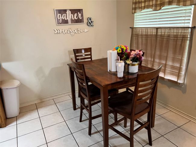 Dining area featuring light tile patterned floors and baseboards | Image 6