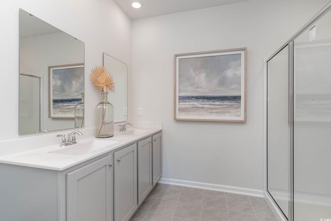 Bathroom with tile patterned flooring, vanity, and a shower with shower door | Image 15