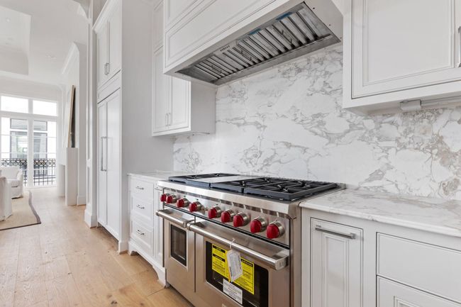 The gourmet kitchen features Energy Star Certified Wolf gourmet appliances including 24" Wolf Microwave, 24" Asko Dishwasher, and this stunning 48" 8-Burner Gas Cooktop (Griddle Optional). | Image 15