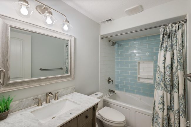 Full bath with vanity, toilet, and shower / bathtub combination with curtain | Image 16