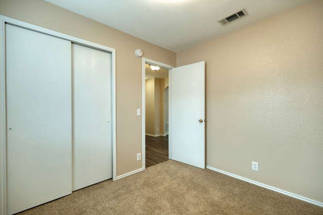 Unfurnished bedroom with carpet, a closet, and baseboards | Image 13