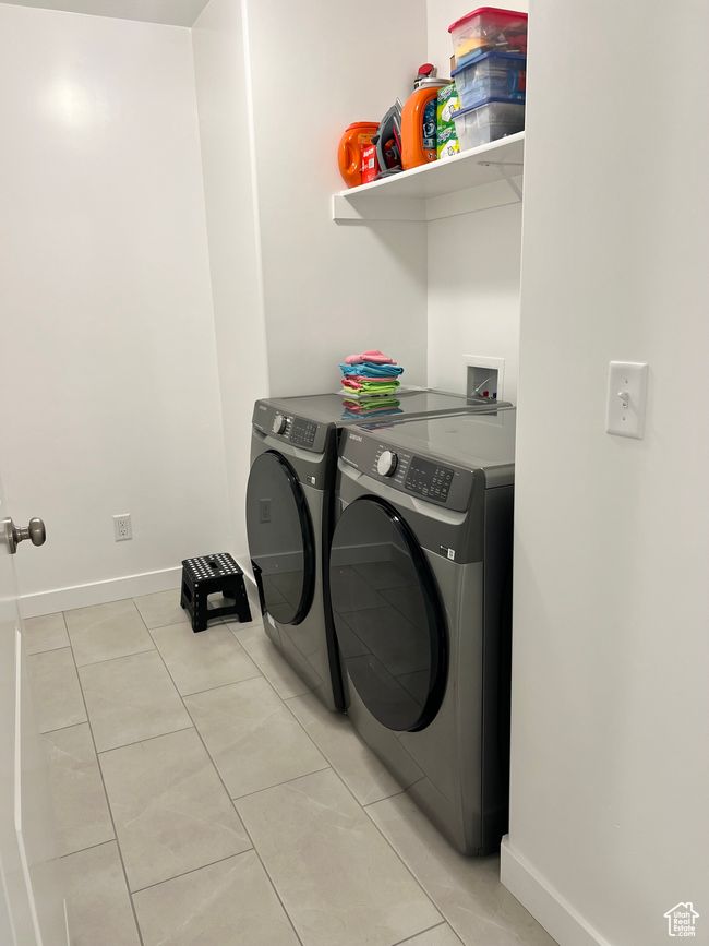 Laundry room featuring independent washer and dryer and light tile patterned floors | Image 14