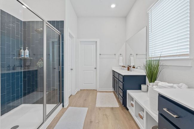 Bathroom with vanity, wood finished floors, a wealth of natural light, and a shower stall | Image 16