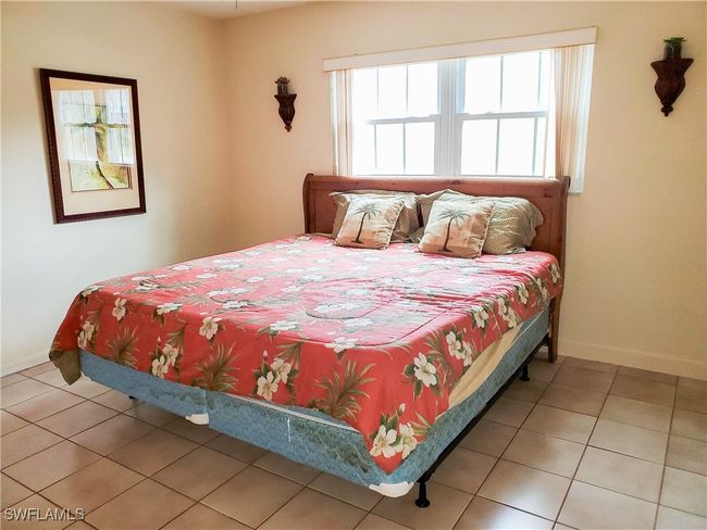 Bedroom featuring tile patterned floors and baseboards | Image 14