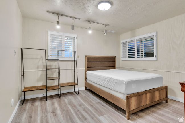 Bedroom featuring wood finished floors and track lighting | Image 22