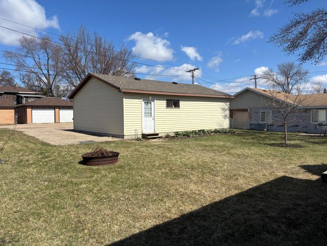 Backyard between garage and house with firepit | Image 31