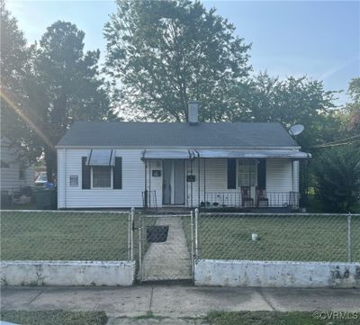 View of front of property with covered porch and a front lawn | Image 1