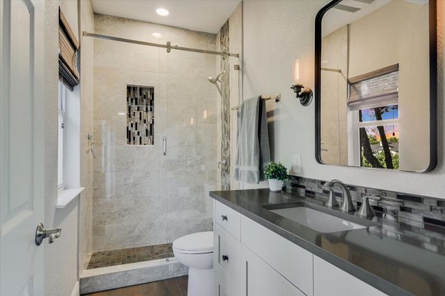 Full bathroom featuring recessed lighting, wood finished floors, a shower stall, toilet, and vanity | Image 16