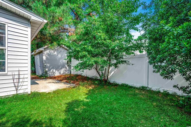 Fenced backyard with a shed | Image 35