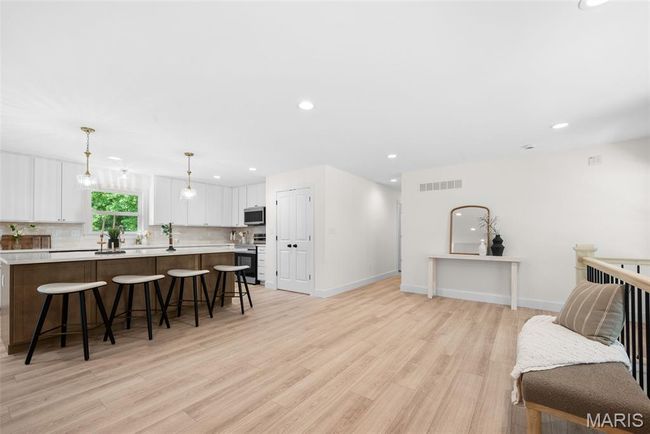 Living area with light wood-type flooring and recessed lighting | Image 7