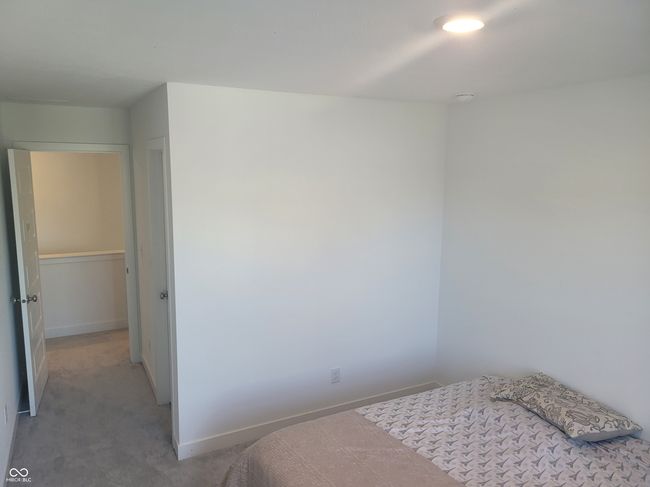 bedroom featuring baseboards and light carpet | Image 12