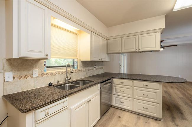 Kitchen has recent double stainless sinks with recent cabinets | Image 13