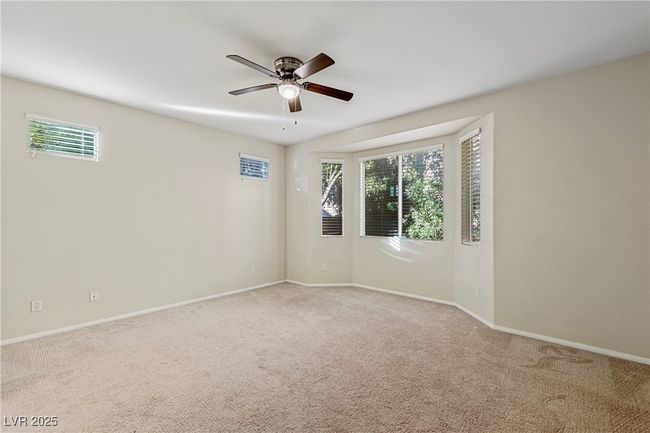 Empty room with ceiling fan, healthy amount of natural light, and light carpet | Image 27