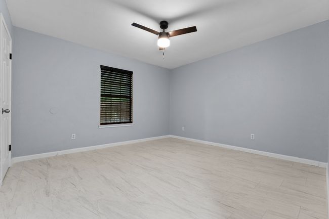 Spare room featuring ceiling fan and baseboards | Image 21