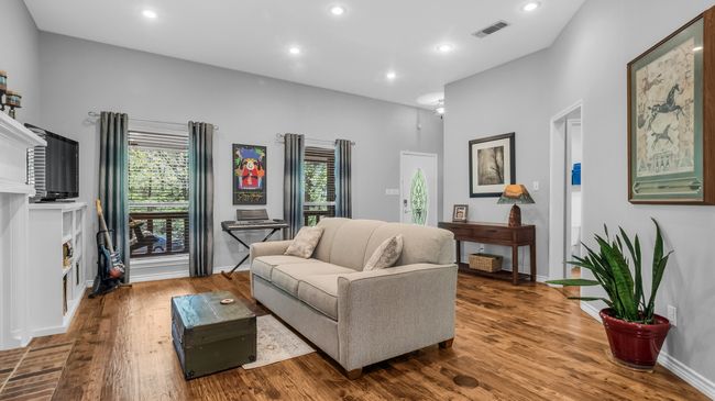 Living area featuring visible vents, plenty of natural light, and wood finished floors | Image 14