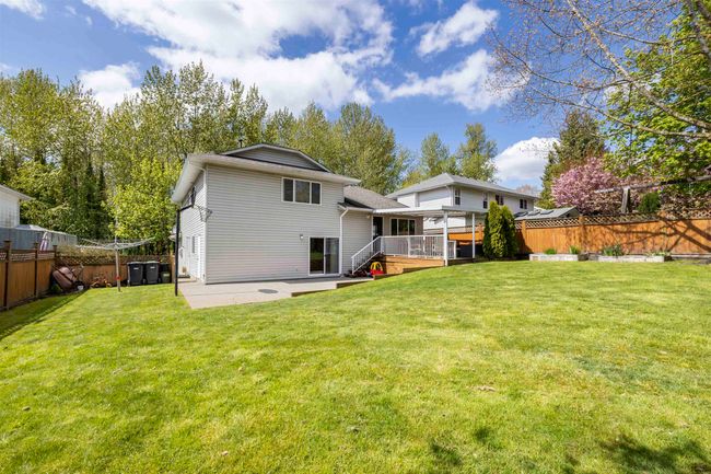 Back of house featuring a wooden deck, a yard, a fenced backyard, and a patio | Image 28