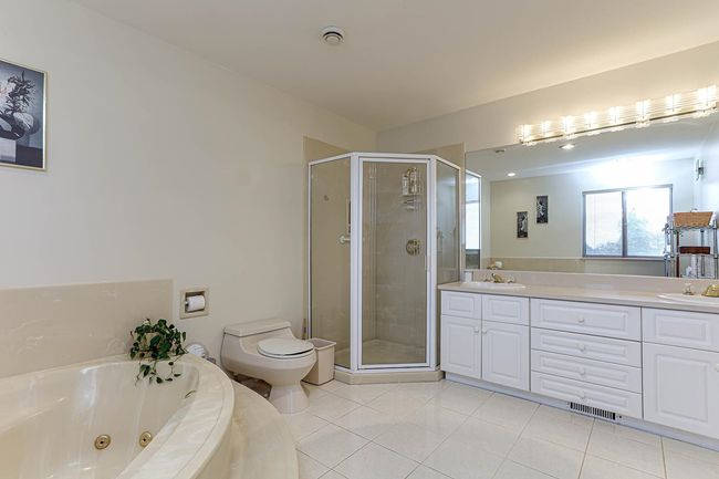 Bathroom featuring a shower stall, a tub with jets, a sink, and tile patterned floors | Image 29