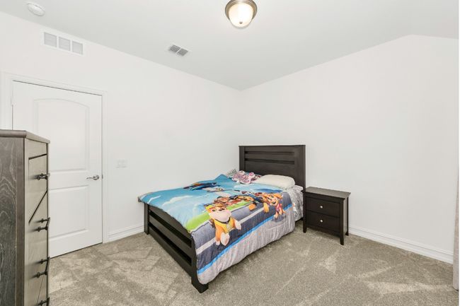 Carpeted bedroom featuring baseboards and visible vents | Image 25