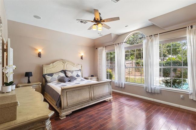 Primary bedroom with large windows and hardwood floors. | Image 14