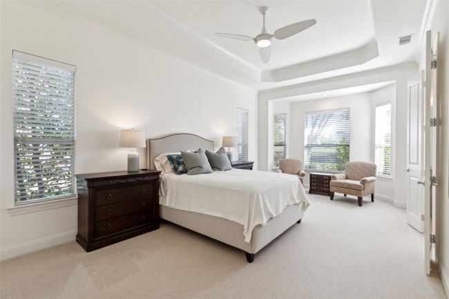 Wonderful and inviting primary bedroom with sitting area overlooking golf course | Image 12